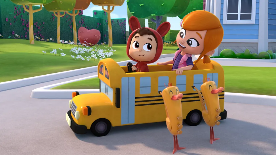 Lea and Pop riding a toy school bus with their musical toys