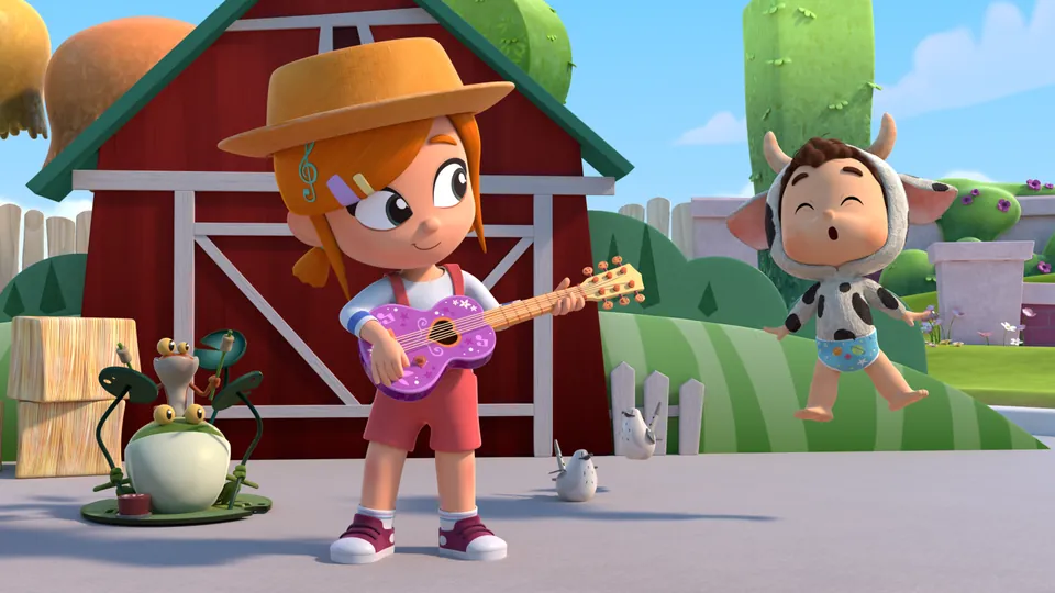 Lea playing guitar outside the red barn on the farm